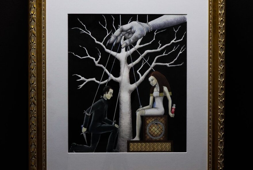 A painting in a gold frame of a tree and people as puppets on the ground being controlled by a giant hand above the tree.