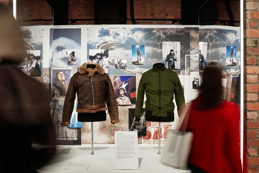 A military jacket and its fashionable counterpart on display.