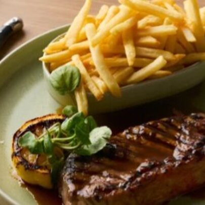Steak and chips on a plate.