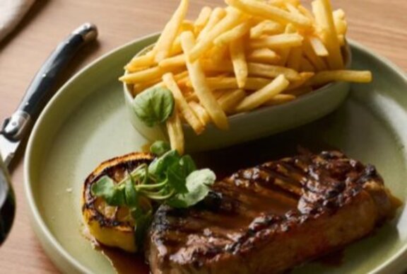 Steak and chips on a plate.