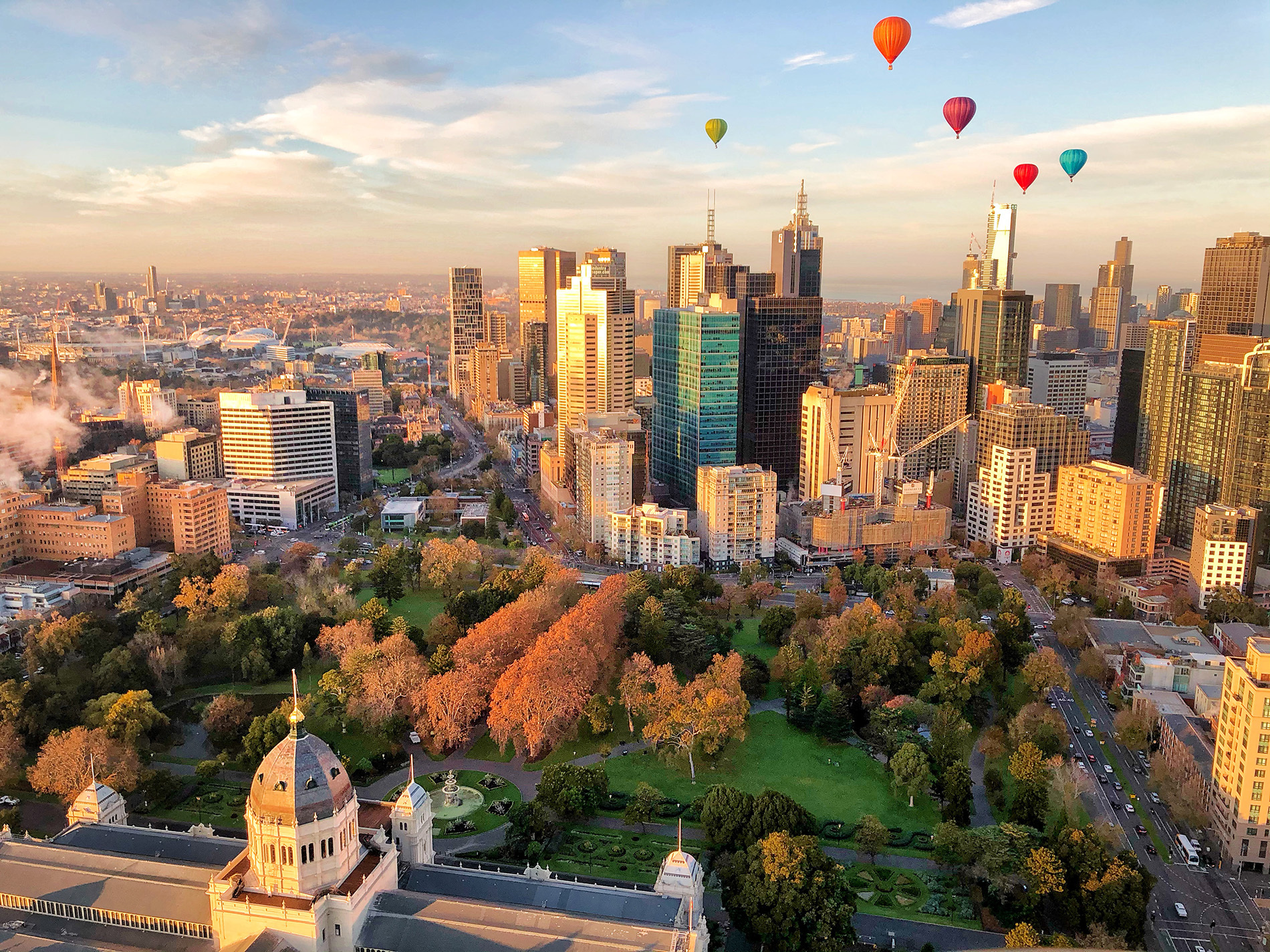 Colourful balloons flying over Melbourne and Carlton Gardens.