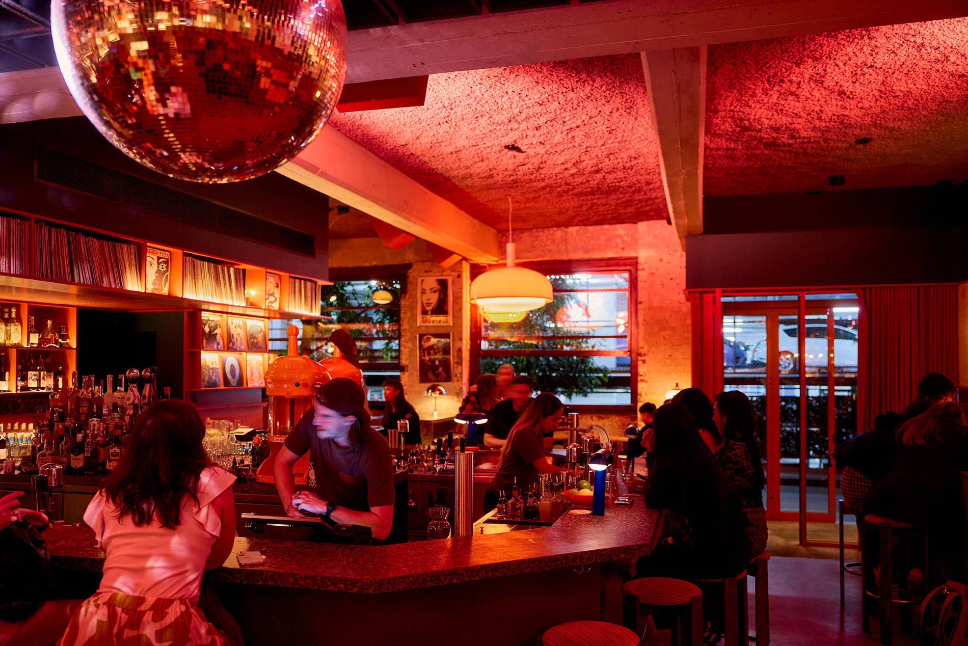 A dimly lit bar with a disco ball.