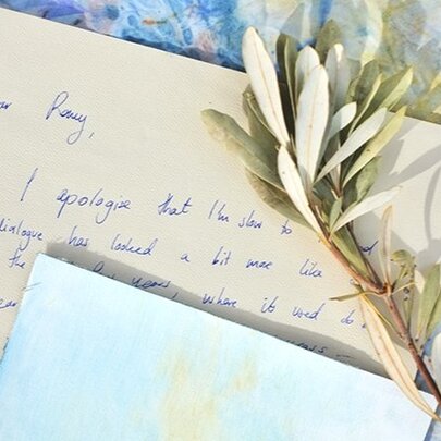 Artwork of handwritten letters with dried frond.