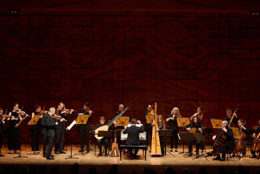 An orchestra on stage performing. 