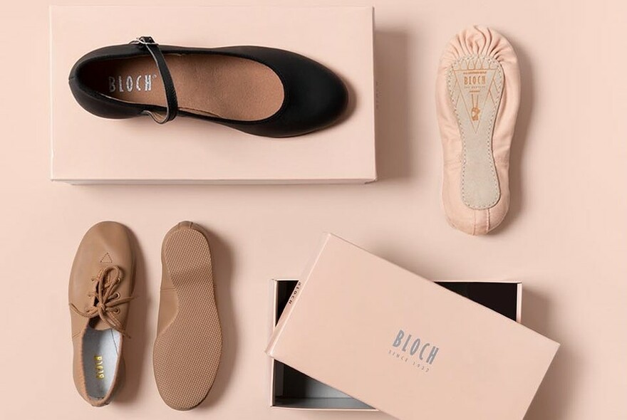 Selection of ballet and dance shoes against a pale pink background.