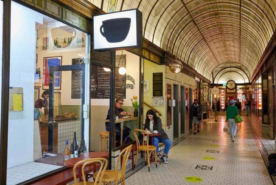 A woman sitting in a cafe at an arcade