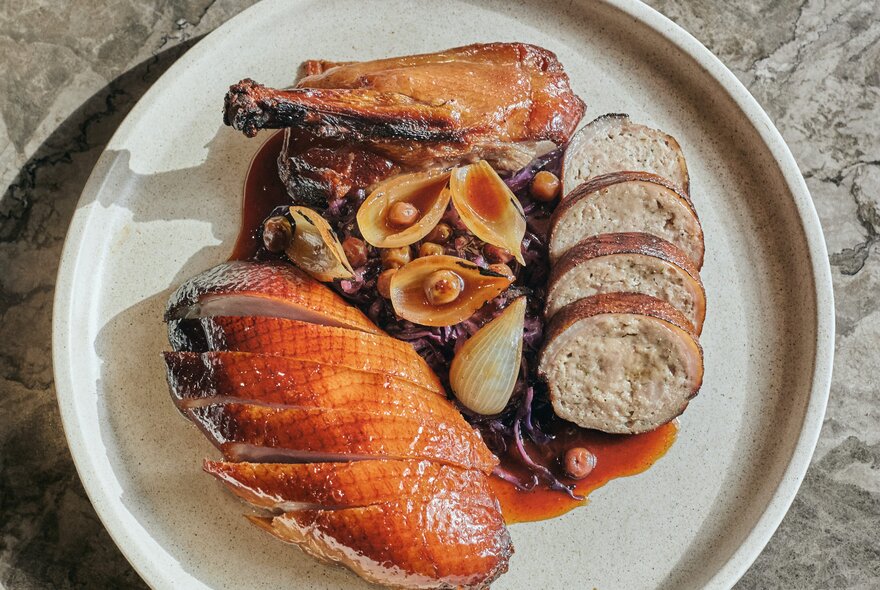Aged duck sliced on a plate with accompaniments. 
