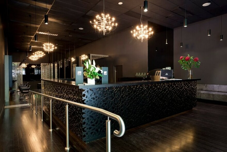 Dimly lit interior image of reception at Manhor Men's Grooming Lounge.