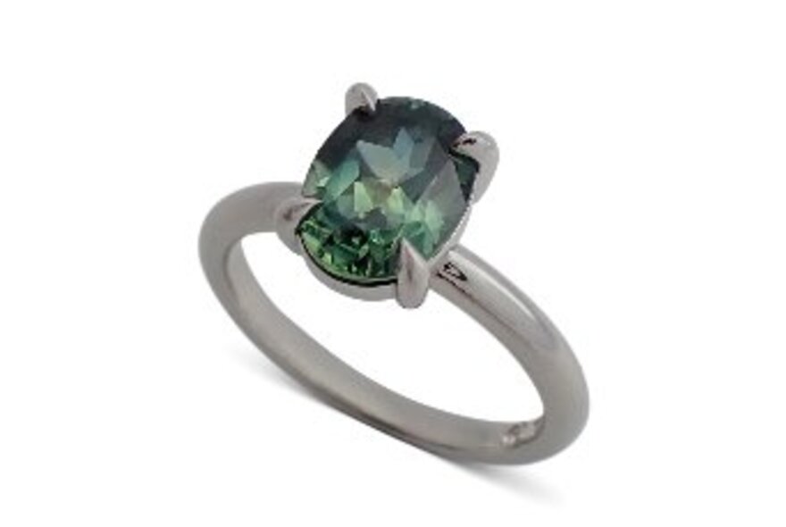 A ring featuring a single green stone. 