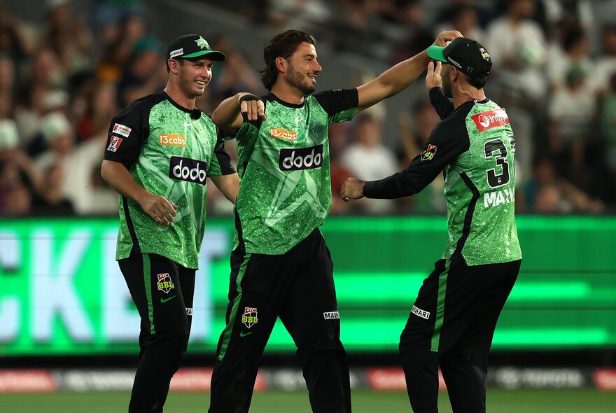 Melbourne Stars players communicate during a BBL match. 