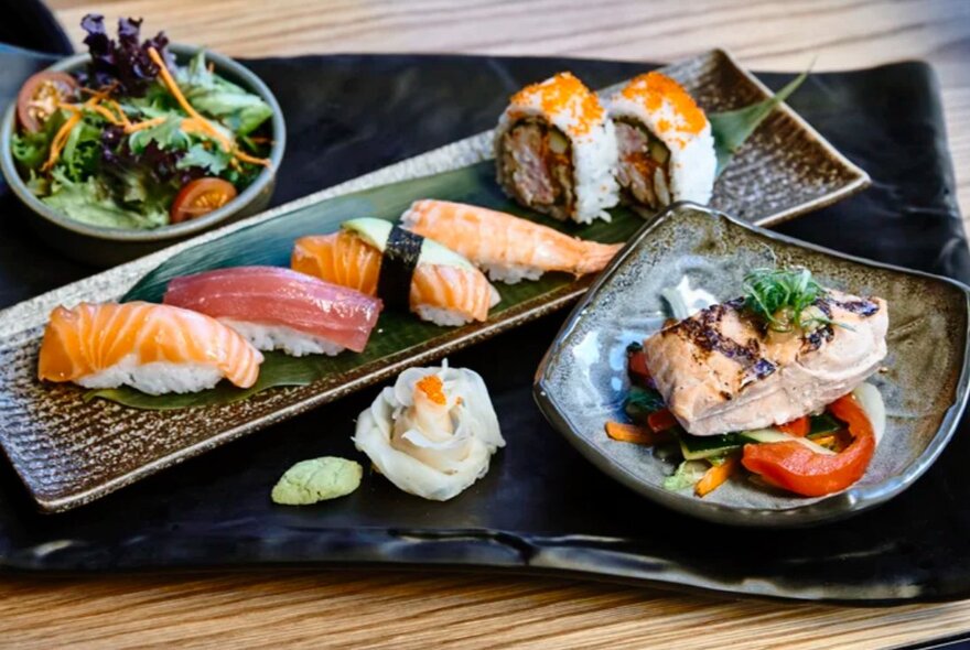 Japanese dishes including sushi, tuna and salad.