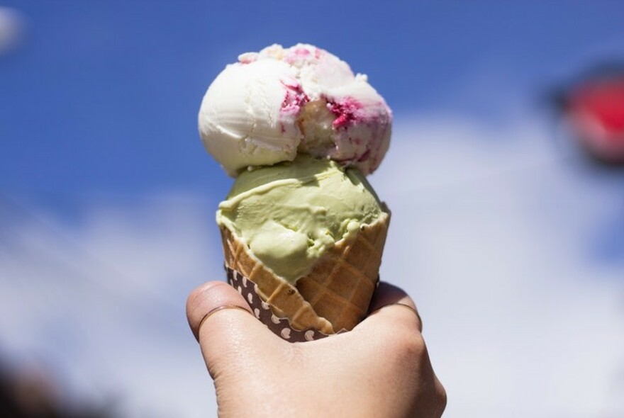 Two scoops of ice cream in a cone.