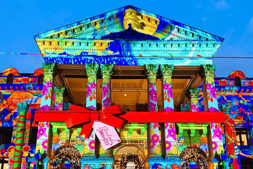 Melbourne's Town Hall lit up with colourful and bright Christmas decorations.