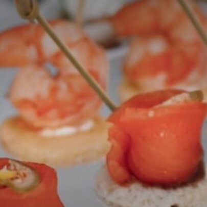 Rows of seafood appetisers on a platter.