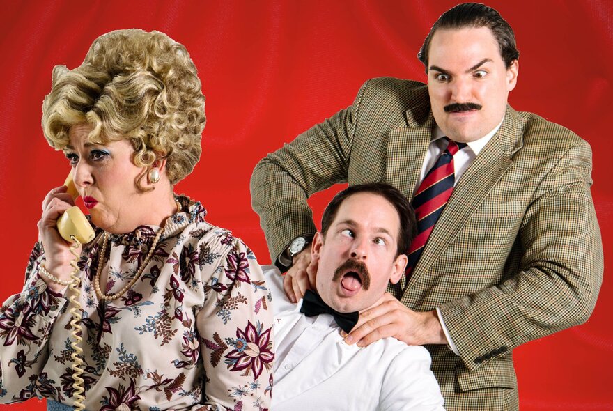 People dressed as characters from Fawlty Towers, with Basil strangling Manuel as Sybil talks on the phone. 