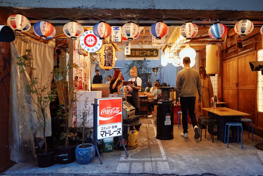 A small Thai Japanese restaurant with hanging glowing lanterns out the front. 