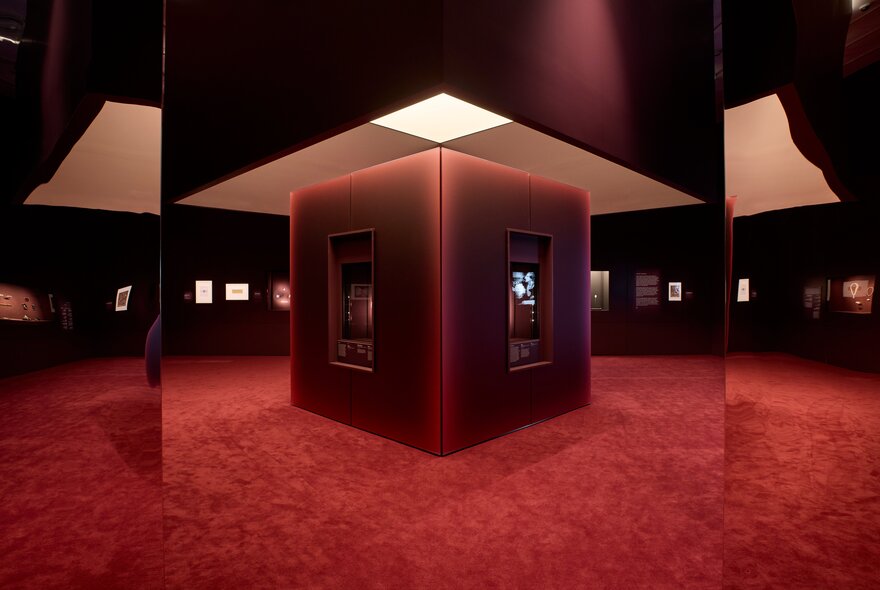 Monolith under skylight in a carpeted venue.