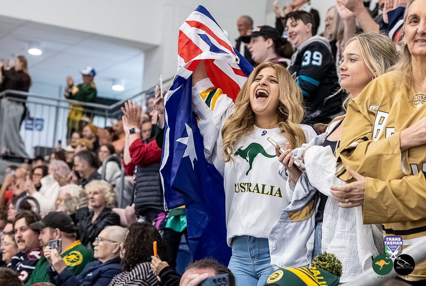 A crowd of people watching Australia play ice hockey.