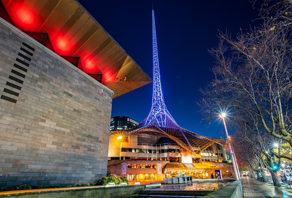 A building with a large glowing spire on top.
