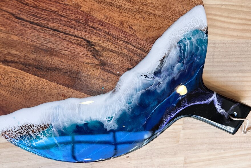 Wooden board with resin wave detail.