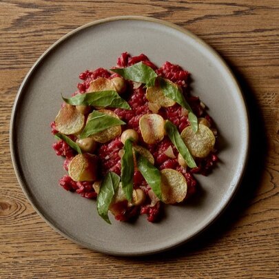 Looking down at a dish of carefully arranged food on a ceramic plate.