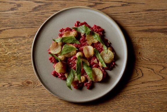 Looking down at a dish of carefully arranged food on a ceramic plate.