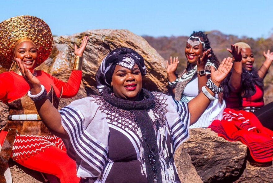 Nobuntu, Zimbabwe's all-female a cappella quartet, wearing traditional African brightly coloured dresses and jewellery.