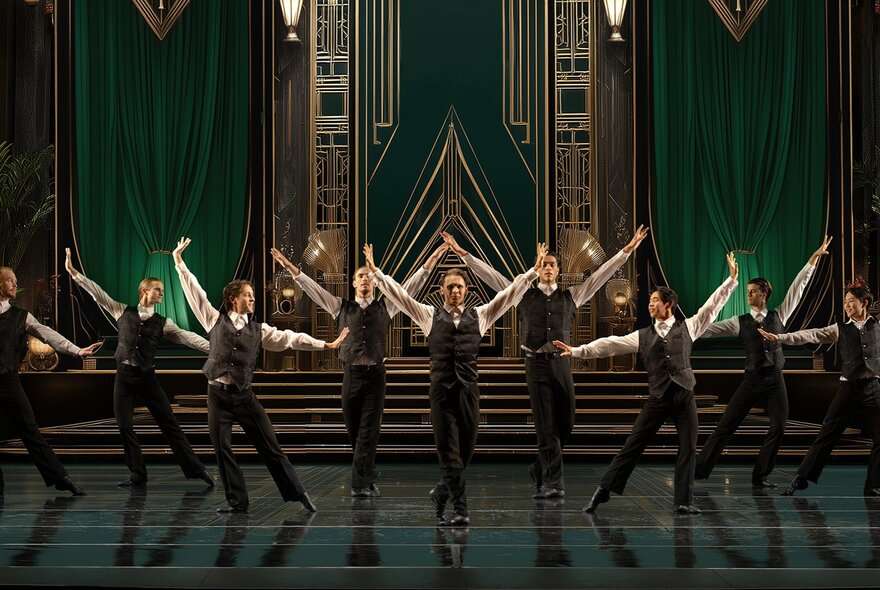 Massed group of male dancers wearing waistcoat suits performing on stage.