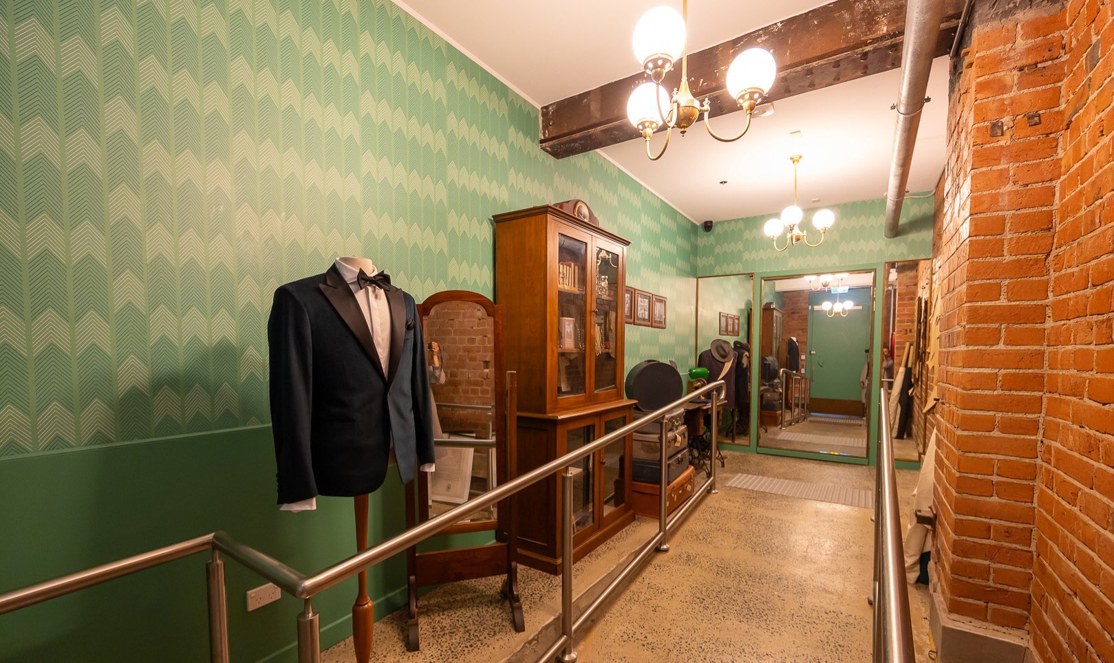 A hallway with old sewing shop details including a suit on a mannequin and an old wardrobe.