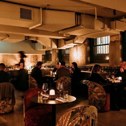 Dimly-lit wine bar with a low ceiling.