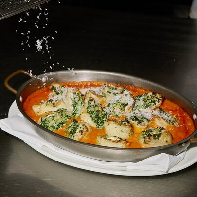 Baked pasta in a silver dish.