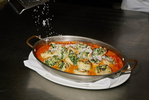 Baked pasta in a silver dish.
