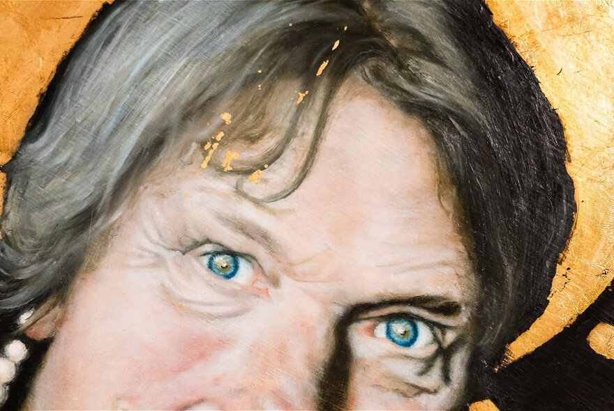 Artwork of a fragment of a person's face with gold halo.