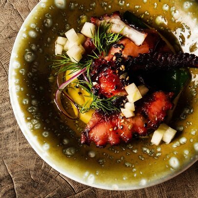 A small plate of octopus in olive oil.