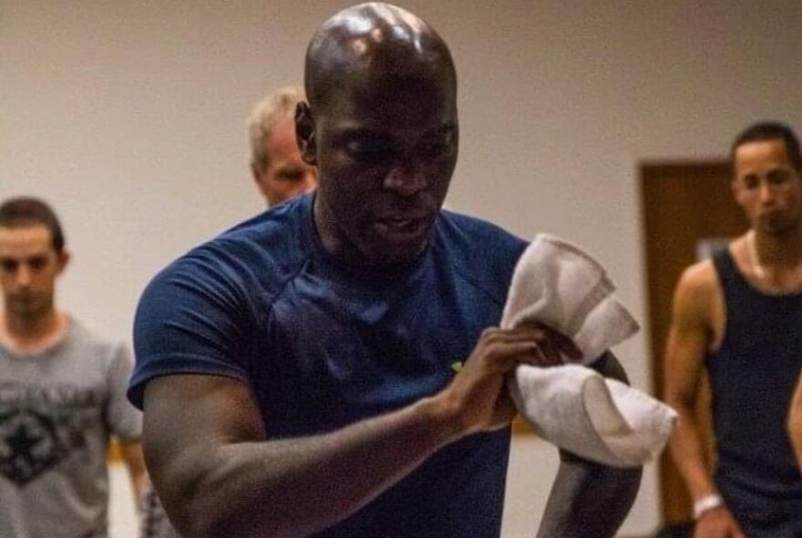 A Cuban dancer leading a dance class with three men dancing behind him.