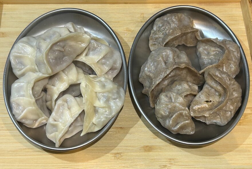 Two plates of Bhutanese dumplings, seen from above.