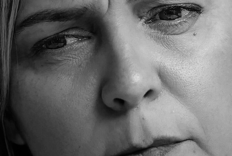 Close-up of a woman's face, black and white photograph.