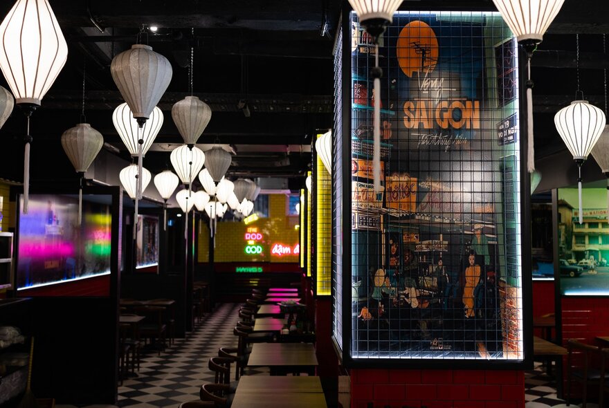 The neon-lit interior of Saigon Square, Vietnamese eatery in Melbourne, with white paper lanterns.