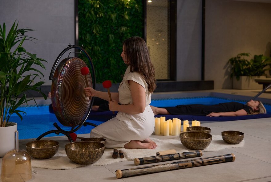 A floating sound bath, a meditative experience where participants lie on lilos on water while listening to vibrations from instruments like gongs and singing bowls. 
