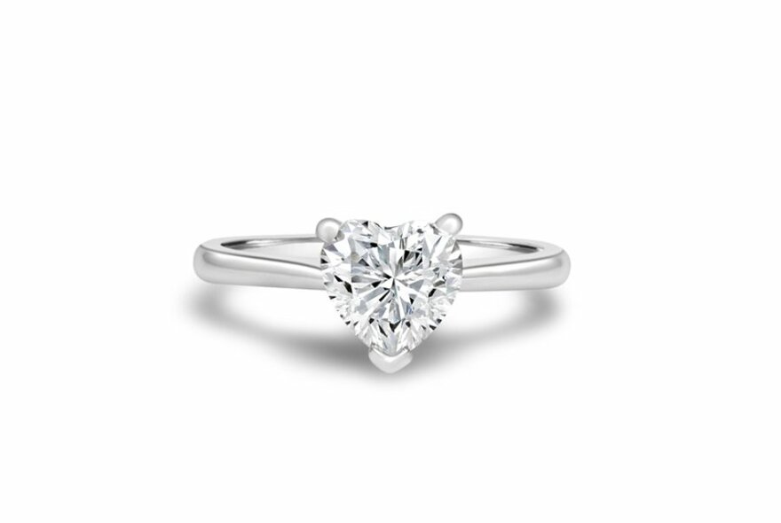 A silver ring with a heart-shaped diamond.