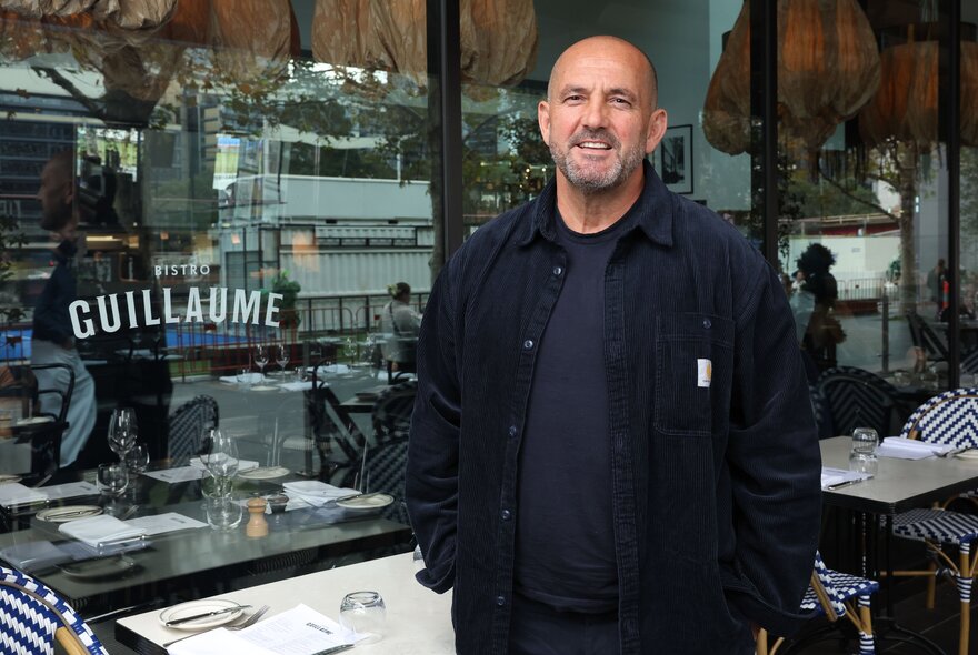 Chef Guillaume Brahimi smiling in front of his restaurant Bistro Guillaume 