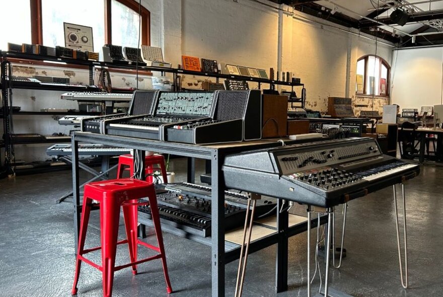 Inside a sound studio with electronic music equipment.