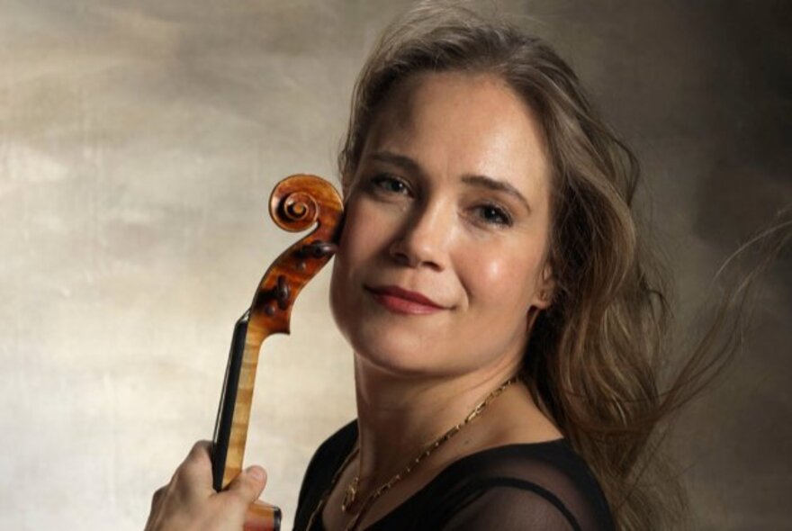 Musician Leila Josefowicz holding a violin.