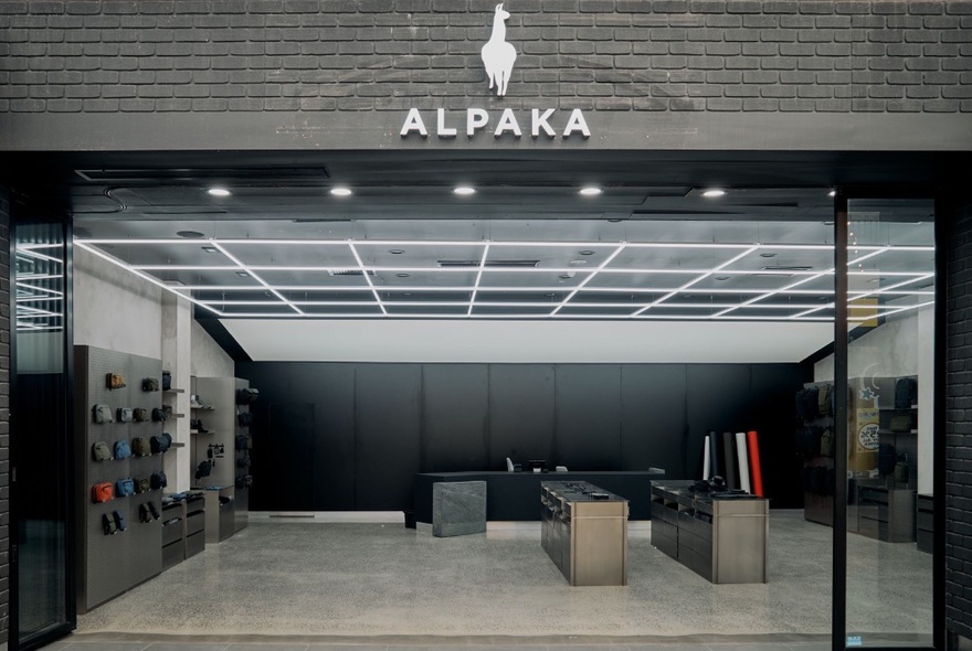 The storefront of the Docklands Alpaka store, with concrete floors and minimalist grey interiors.