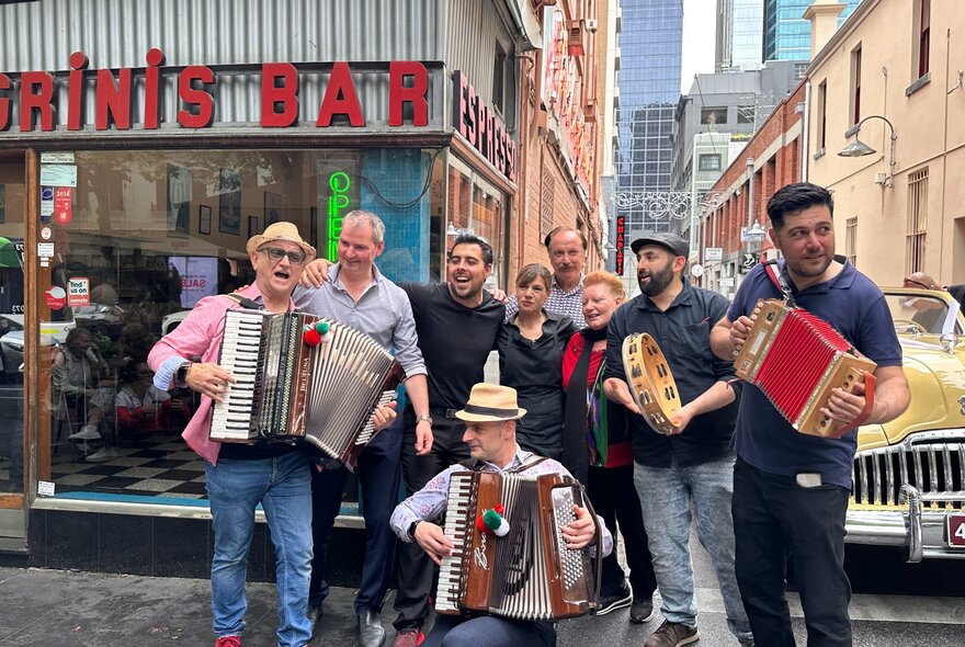Italian musicians with accordions standing in a laneway outside iconic Melbourne cafe Pelligrinis.