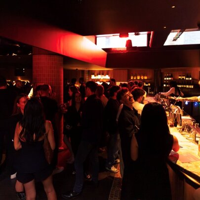 A dark crowded bar. 