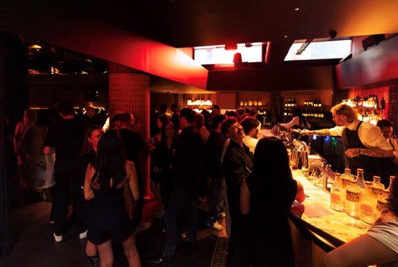A dark crowded bar. 