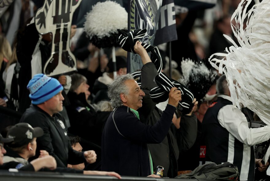 Collingwood football fans in the stands during a match.