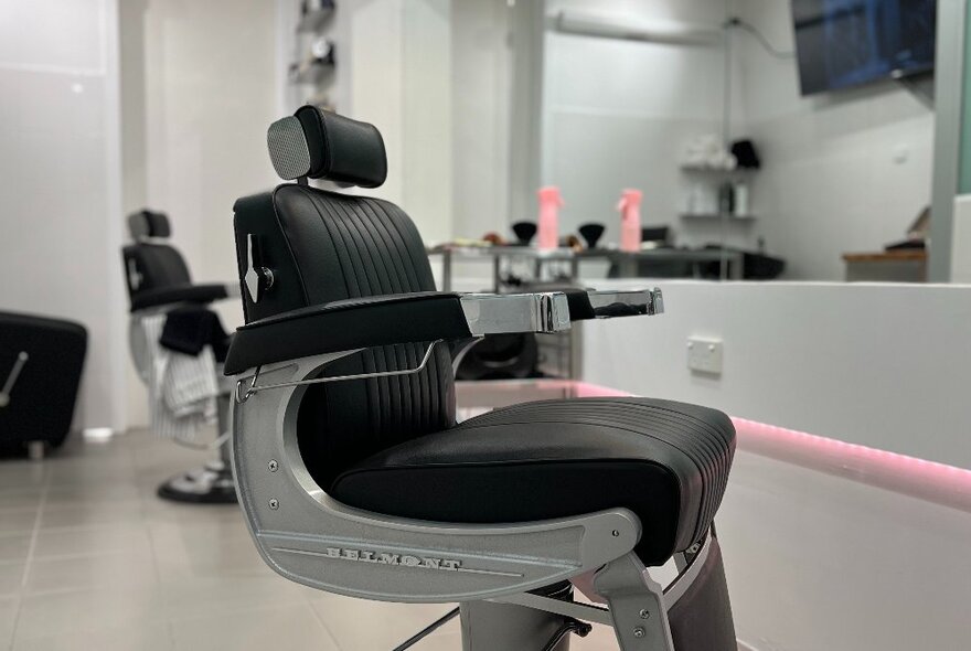 A comfortable looking Belmont shaving chair at a barber shop.