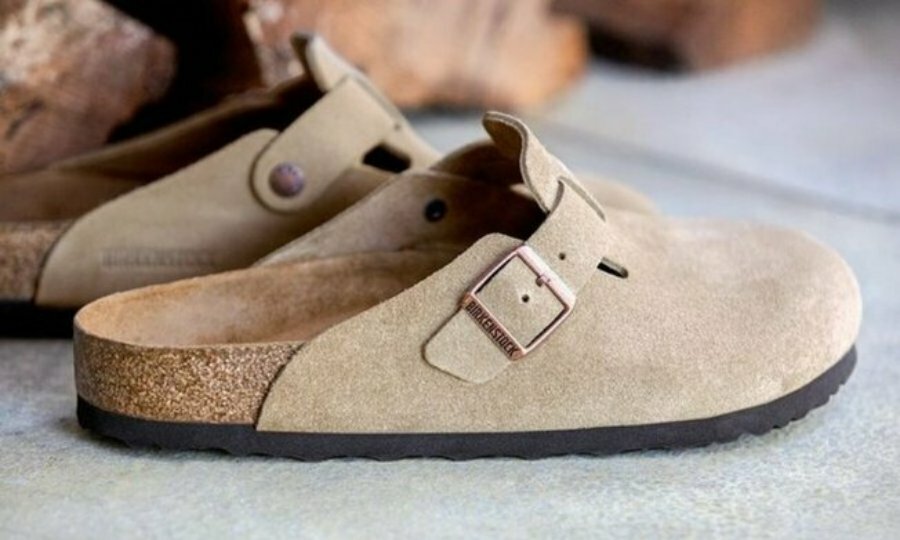 A pair of brown suede Birkenstock Boston clogs.